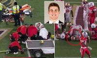 College football player left motionless by awkward hit is rushed to Boston hospital in frightening scene