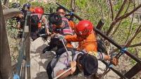 Tourist dies after clinging to rocks then falling 80 metres down sheer cliff face
