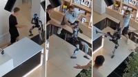Man shoves humanoid robot in Russia, then store clerks scramble as it starts kickboxing