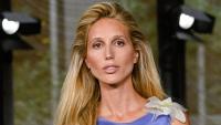 Princess Olympia looks like a supermodel as she storms the runway in curve-hugging backless dress
