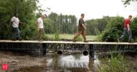 MIT researchers are giving millions of plastic bottles a new life by turning plastic waste into homes, decks and bridges using AI robots