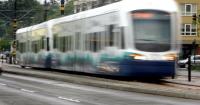 Seattle light rail train and empty school bus collide