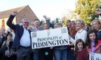 Up to 500 councillors from villages across Britain consider holding their own independence referendums after Piddington migrant camp protest vote
