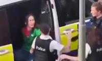 Belgian police officer is filmed brutally slapping handcuffed woman across the face during arrest in case that has sparked fury