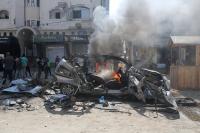 Gaza building damaged by Israeli strikes collapses, killing 20 including children