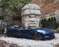 Artist who went viral for crushing a Tesla will ride ‘bomb’ like a bull for anti-war performance