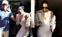 Braless Kim Kardashian gives onlookers an eyeful as she steps out with Christian Louboutin in Paris... after being awarded just one Euro in hotel robbery case