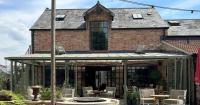 Tourism business asks to retain conservatory put up without planning consent