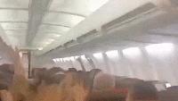Plane passengers scream in harrowing mid-flight video as violent shaking sends cabin ceiling panels flying