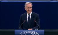 Heckler shouts 'USA! USA!' as Canada's PM hails his country's EU 'associate membership' - and takes a swipe at Trump 