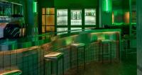 studiomateriality translates lucha libre into green-lit, stainless-steel bar in athens