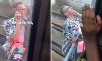 Idiot man in Hawaiian shirt seen enjoying the breeze as he rides OUTSIDE Philadelphia train traveling at high speed