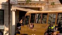 Wild moment a New York City school bus crashes into an apartment building during rush hour