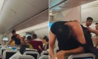 Two men throw punches at each other during flight from Bangladesh to London, with one man losing his T-shirt during the brawl