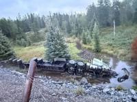 Transport truck recovered from creek after 60-foot plunge
