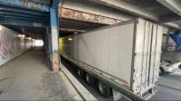 Truck wedged under downtown Calgary rail bridge slows morning traffic