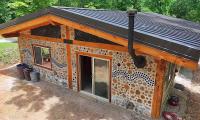 At 50, Missouri man cashed out retirement to build home from cedar rounds and recycled bottles