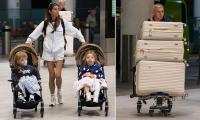 Amy Childs wears a 'Mrs Delbosq' tracksuit as she arrives at the airport laden with luggage ahead of her second wedding in Spain