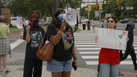 Furious masked Ed Sheeran protestors shout abuse at his fans outside Philadelphia concert