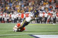 Hawkins shines, defense delivers to lead Mountaineers in 38-27 victory against 25th-ranked Virginia