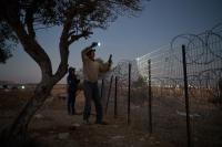 World Associated Press A flashlight and unseen settlers: Photographer conveys West Bank family's nightly watch in 1 photo