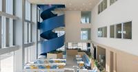 blue spiral staircase anchors ERRE’s harbor-side workspace in valencia