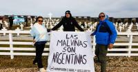 Replica of the flag shown by Argentina's football team unfurled at Darwin cemetery