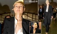 Strutting A-list fashion designer in daring outfit suffers frenzied courthouse MALFUNCTION moments after appearing on charges of running sweatshop