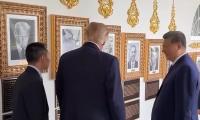 Moment China's President Xi bursts into laughter as Trump shows him mocking 'autopen' portrait of Biden
