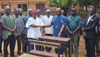 Binaba Chief donates dual desks to Binaba Primary School to end furniture cr