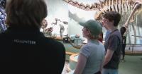 Dinosaur actors check out dinosaur fossils while in Denver