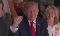 Donald Trump met with roaring cheers from college football fans in Tennessee... as president jets in for SEC showdown