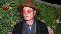 Johnny Depp takes bite of plant backdrop at Las Vegas event as he raises toast