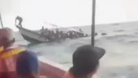 Shocking moment packed tourist boat capsizes in rough seas throwing terrified passengers into choppy waters