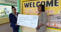 Providence Bahamas and PwC Bahamas present C.W. Sawyer with funds to purchase GLAT workbooks for students