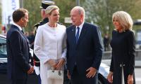 Charlene's privilège du blanc: Monaco Princess is elegant in a white trouser suit as she joins the Macrons to meet Pope Leo
