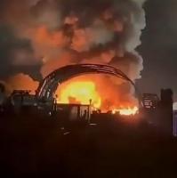 Huge blaze erupts on industrial estate with explosions heard & plumes of smoke seen for miles – as trains cancelled