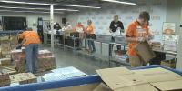 Volunteers pack backpacks and Thanksgiving boxes at first-ever volunteer-a-thon