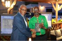 Sir Rodney Receives Signed Copy of Robinson’s Book on Caribbean Survival