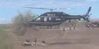 Responders rescue driver stranded on top of submerged car as strong floodwaters flow through Arizona