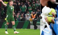 Ireland's clash with Austria is HALTED as furious fans throw hundreds of tennis balls onto the pitch in protest at matches against Israel going ahead