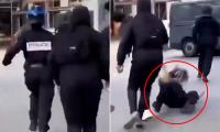 Policewoman is chased down the street, kicked to the ground and beaten by mob as riots rock France