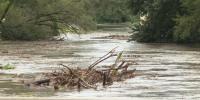Iowa creek rises over banks, slams debris into bridge supports