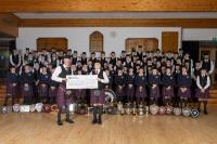 Schoolboy piper confronted by city centre mob presents £19,000 cheque to band after fundraiser