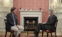 Moment Tucker Carlson tells an incredulous Jacob Rees-Mogg that Britain would have been better off LOSING Second World War - but says he is not a Nazi supporter