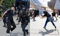 Spanish protests against holidaymakers explode into violence as riot police charge fence-hurling demonstrators amid fight for tax hikes on tourist apartments