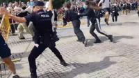 Thousands flock to Spain’s streets as anti-tourism protests erupt into violence with fences thrown at riot cops