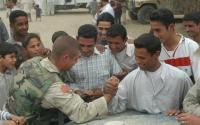 From the archives: A US soldier arm-wrestles an Iraqi man on the hood of a Humvee, 2003