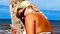 Apollonia Llewellyn leaves fans hot under the collar as she straddles a TREE in tiny bikini while on beach holiday