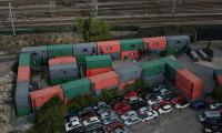 Shipping container village hailed as a 'dream for all homeless people' is making life a 'living hell' for neighbours - who claim residents are trespassing on their £500,000 properties and women are too scared to go out alone